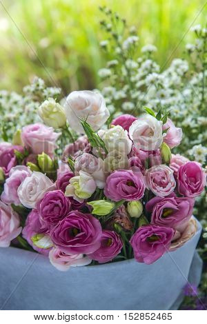 Beautiful bouquet of pink roses on white basket