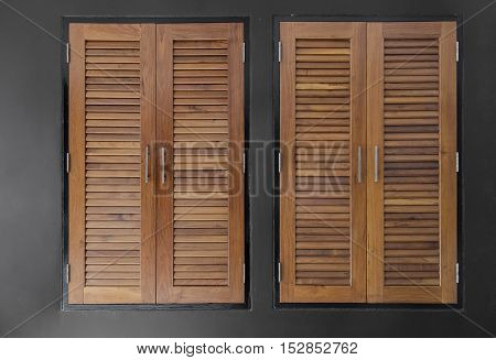 brown wood window on black stone wall