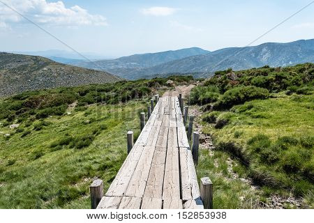 Small wooden bridge in the mountain a sunny day