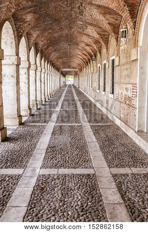 Aranjuez Spain - October 16 2016: Arches and passageway at the Palacio Real Aranjuez located in the Royal Site and town of Aranjuez Madrid province Spain