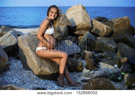 Pregnant smiling  woman on the sandy beach