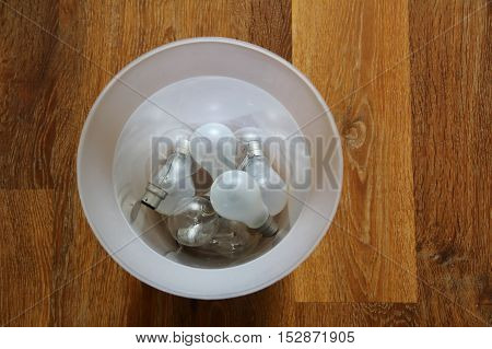 Inefficient Tungsten Light Bulbs Discarded In A Trash Can - Environmental Concept
