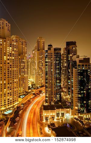 DUBAI, UAE - OCTOBER 07, 2016: A night shot of the popular Jumeirah Beach Residence (JBR) in Dubai Marina showing light trails of moving cars