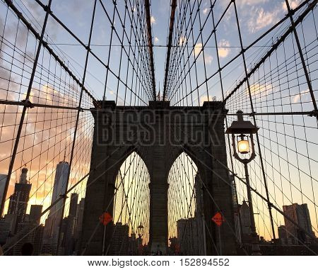 Silhouette of Brooklyn bridge and building in Manhattan with the sunset sky between Manhattan and Brooklyn, New York