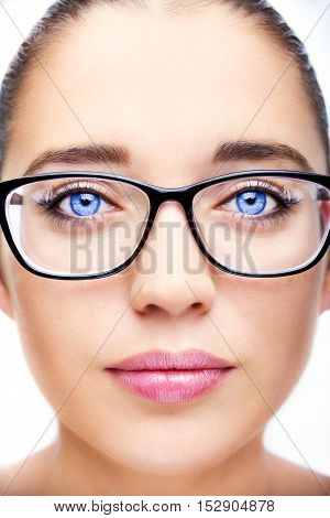 Attractive young optician woman with blue eyes In glasses