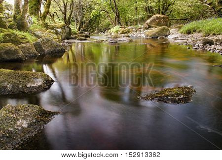 River glencree slowly flowing displaying beautiful reflections in the water