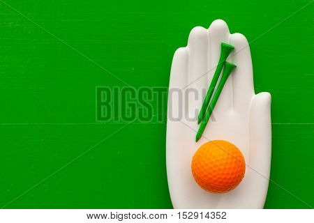 Detail of artifical hand with golf equipments - Flat Lay Photography