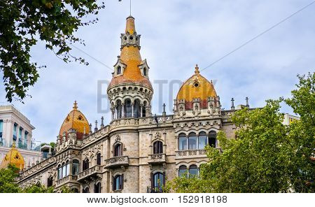 Cases Antoni Rocamora building with orange roofs in Barcelona, summer Spain