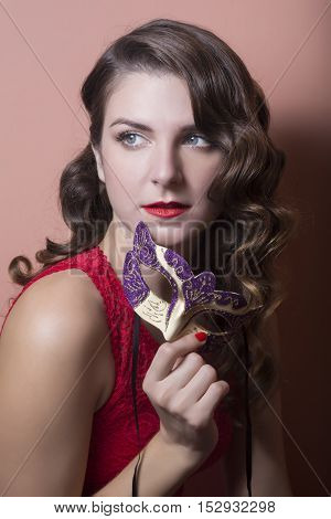 Beautiful Woman Holdind A Carnival Mask. Halloween Holiday Concept.