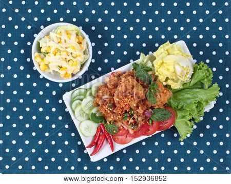 Spicy sour fried chicken salad (Yum Kai Zap in Thai) .