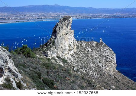 Seascape with a famous rock Sella del Diavolo - the Devil's Saddle the beach il Poetto and the city Cagliari in Sardinia Italy.