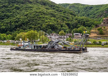 Trechtingshausen Germany - May 23 2016: Service vessel Carl Straat on the Rhine River near Trechtingshausen in cloudy weather Rhine Valley UNESCO World Heritage Site Rhineland-Palatinate Germany. Service vessel Carl Straat has a diving bell allowing to wa