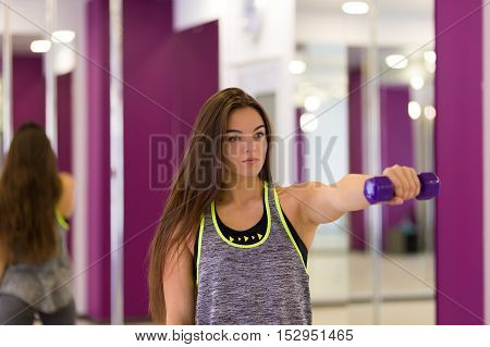 Pretty woman working out at the gym