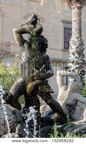 TRAPANI ITALY - AUGUST 11 2016: Triton fountain on the Piazza Vittorio Emanuele II built in 1951 by Domenico Li Muli.