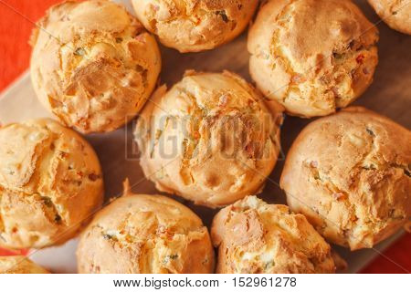 Tasty homemade salty cupcakes served on wooden plate selective focus
