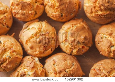 Tasty homemade salty cupcakes served on wooden plate selective focus
