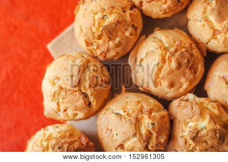 Tasty homemade salty cupcakes served on wooden plate selective focus