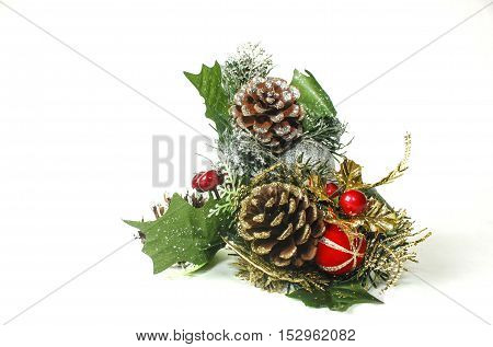 Christmas time decorations. Cones and red balls on white background.