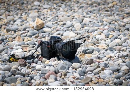 PALEOCHORA, CRETE, GREECE - JULY 2016: Nikon D700 camera at stony beach of Paleochora town on Crete island, Greece