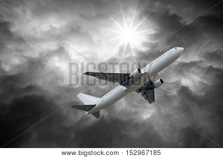 Airplane On Dark Stormy Sky And Sun