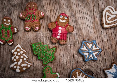 Colorfully Christmas Cookies On Rustic Wooden Background, Gingerman And Tree