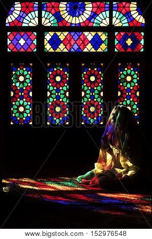 Iran Shiraz - September 2016: Persian girl in multi-colored mosque Nasir ol Mulk