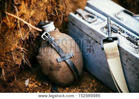 German military ammunition of World War II on ground. Flask, box of ammunition.