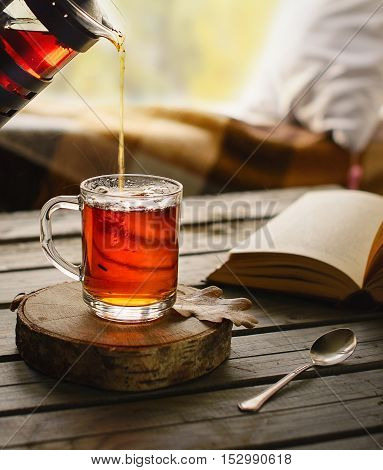 Herbal tea in glass cup in cozy ambience.