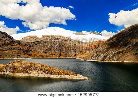 Peaceful lake with a snow covered mountain in the background