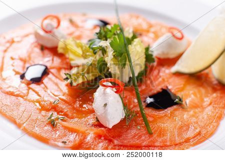 Carpaccio , Salmon Filet Salad. Summer Launch, Healthy Eating Concept. White Plate With Sauce. Salad