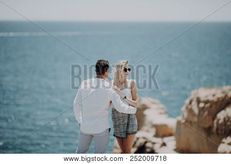 Couple On The Cliff With Beautiful Ocean View.