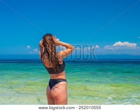 woman sunbathing on the beach summer travel holidays
