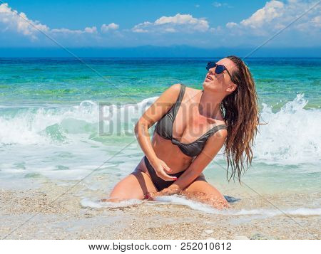 woman sunbathing on the beach summer travel holidays