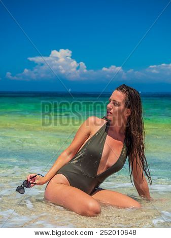 woman sunbathing on the beach summer travel holidays