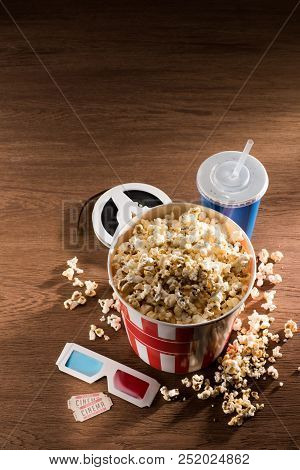 Close Up View Of Paper Bucket With Popcorn, Soda Drink, 3d Glasses And Retor Cinema Tickets On Woode