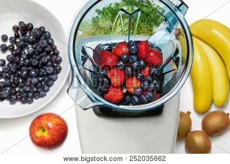 Strawberry And Blueberries In Blender With Ingridients For Smoot