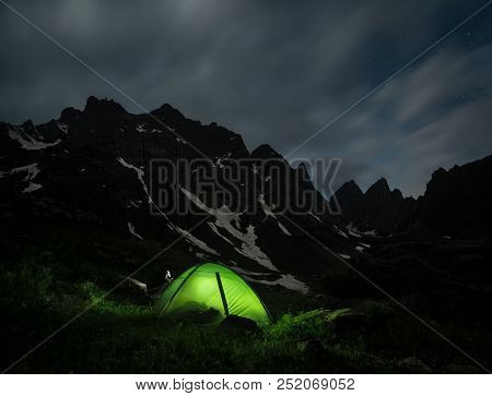 Night Landscape Of A Camping Tent And A Mountain Range At The Background. Chaukhi Mountain Range At 