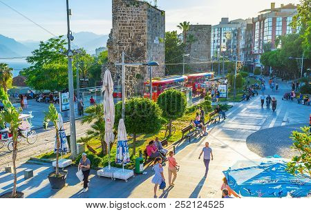 Antalya, Turkey - May 11, 2017: The Crowded Cumhuriyet Street With Ancient Towers Of City Wall, Ridi