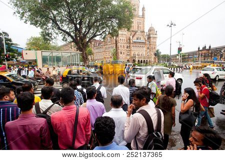 MUMBAI, INDIA - JULY 3 2018: People are crossing the road at square in evening time 