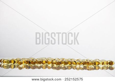 Fish Oil Supplement Capsules Isolated On White Background