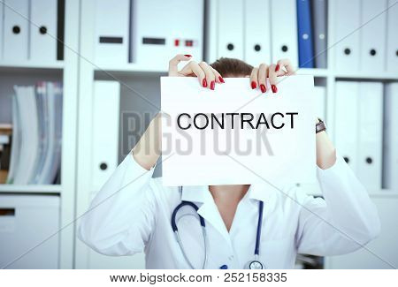 Hands Of Female Medicine Doctor Ripping Contract. Photo With Depth Of Field.