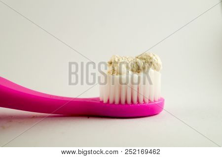Herbal Toothpaste On Pink Toothbrush Isolated White Background