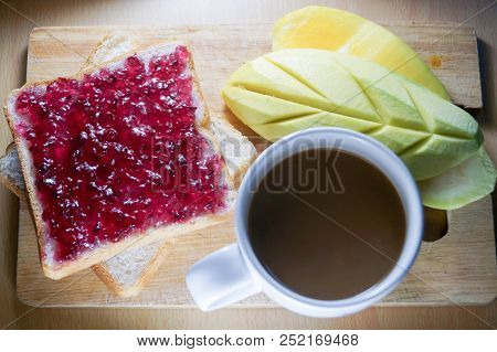 Morning Breakfast Have Blueberry Jam On Brown Bread With Mango And Coffee. It Is Healthy Food And Go