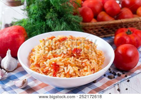 Bowl Full Of Rice With Tomatoes On White Wooden Background
