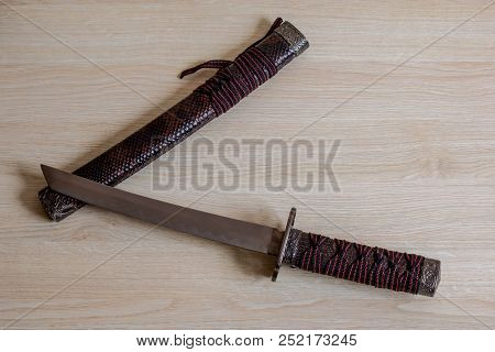 Japanese Samurai Sword Close Up On Wooden