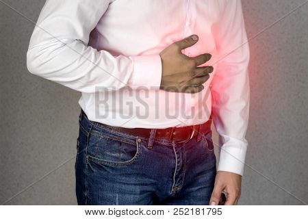A Man In A White Shirt Holds On To The Abdomen, Abdominal Pain, Heartburn, Close-up