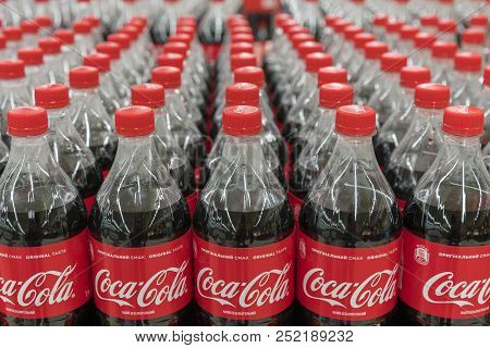 Kiev, Ukraine. July 22 2018 Coke In Bottles On Row Of Shelf Display For Sale In Hypermarket Grocery 