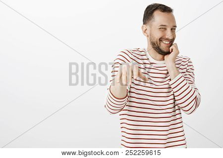 Portrait Of Impatient Pleased Cute Gay Boyfriend In Striped Shirt, Blushing While Man Making Proposa