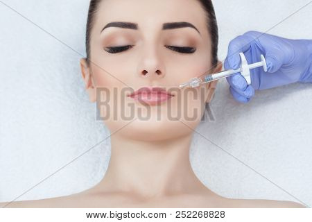 The Doctor Cosmetologist Makes The Rejuvenating Facial Injections Procedure For Tightening And Smoot