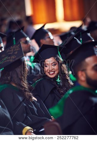 Group Of Happy Graduate Students In Gowns On Graduation Ceremony